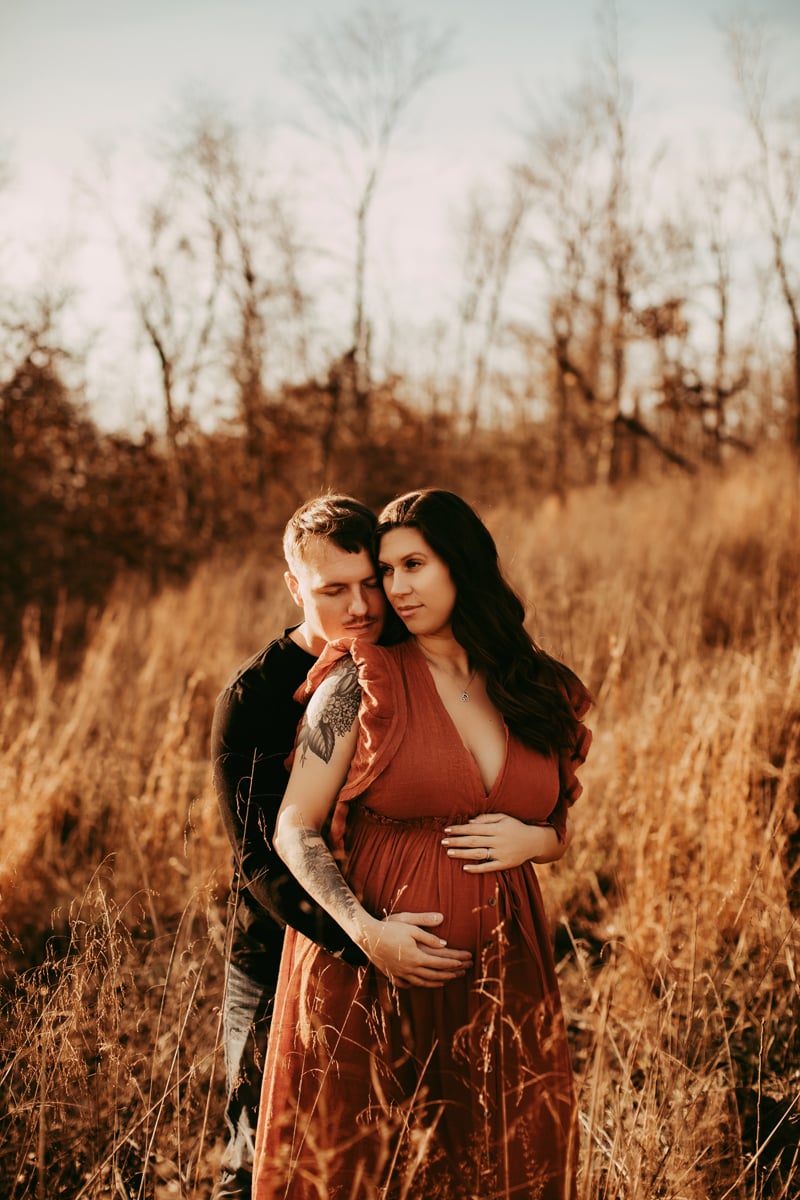 Golden Hour Maternity Session - Couple standing in grassy field