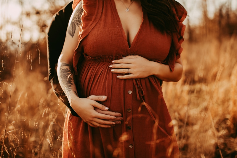 Golden Hour Maternity Session - couple holding pregnant belly